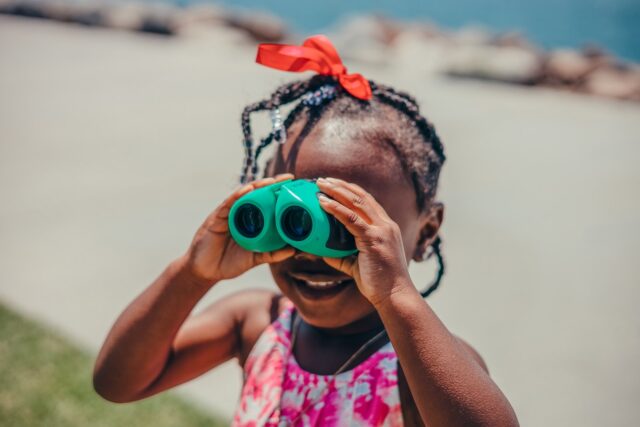 Close Up Shot of a Girl Using Binocular for scavenger hunt