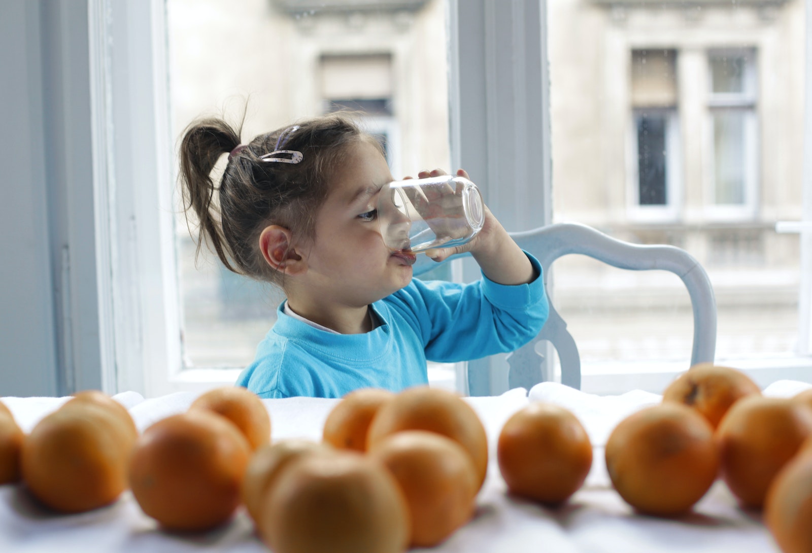 A Girl Drinking Water from a Glass